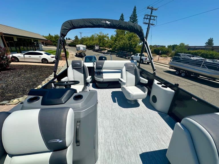 Modern boat interior with spacious seating and steering console, ideal for recreational boating.