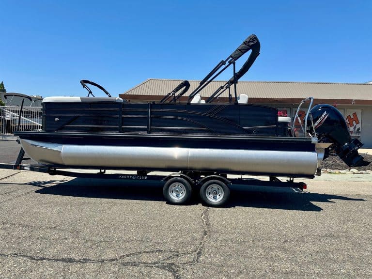 Pontoon boat on trailer, ready for water, ideal for leisure and fishing adventures.