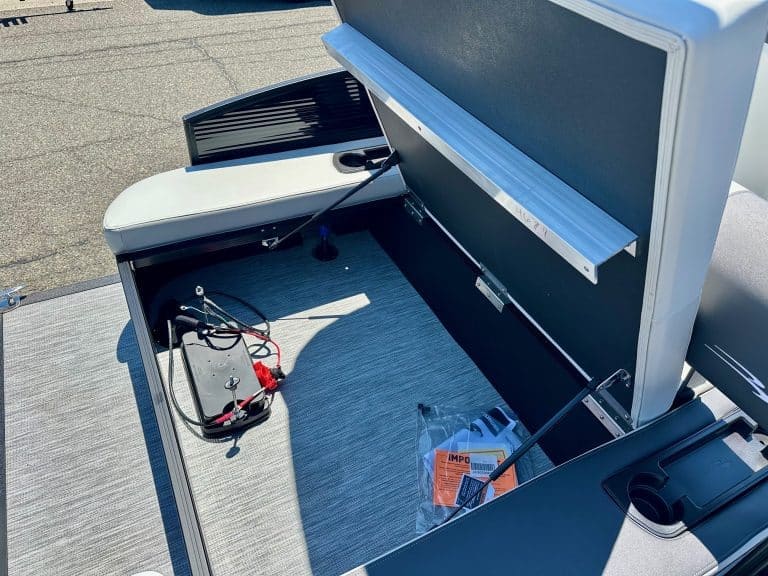 Custom boat dashboard with electronic controls and storage compartments.