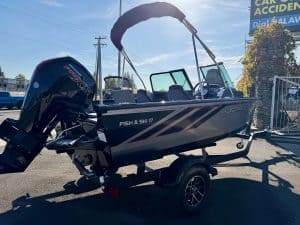 Opti fishing and ski boat with outboard motor on trailer for sale.