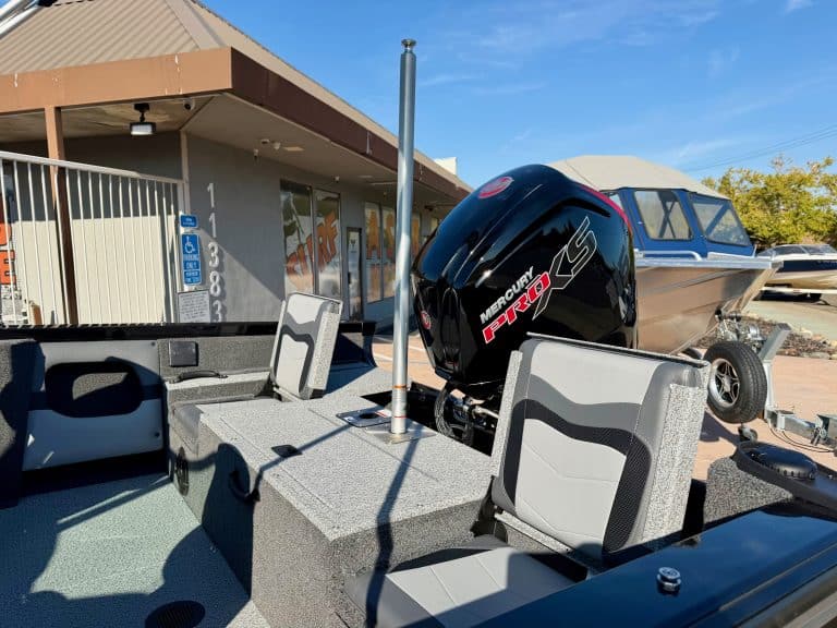 Boat with Mercury outboard motor at a marina, ready for water activities.