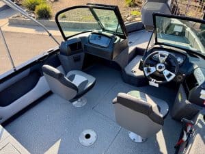 Boat helm station with steering wheel, navigation system, and comfortable seating for marine operati.