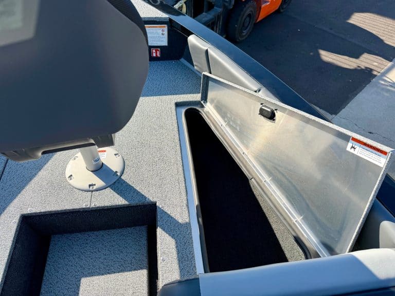 Boat storage compartment with open lid on a marine vessel.