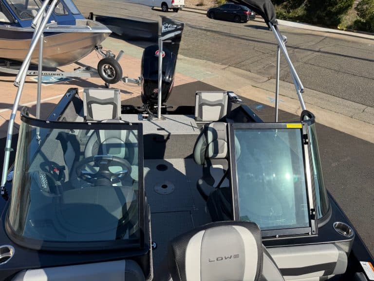 Modern boat with dual windshields and seating, ideal for recreational boating.