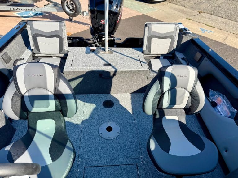 Boat interior with seating and outboard motor for fishing or recreation.