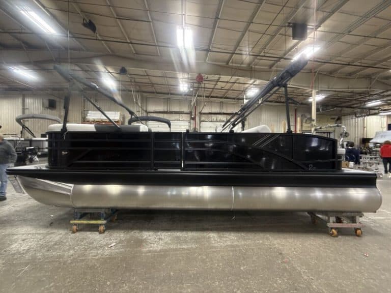 Custom pontoon boat being built in a manufacturing facility for marine leisure.