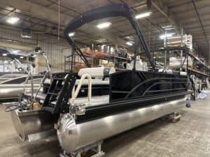 Modern black pontoon boat with canopy, ready for water adventures at ASFB Marine.