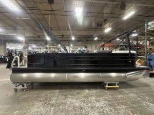 Pontoon boat being assembled in a manufacturing facility.