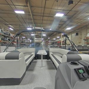 Luxury pontoon boat interior with spacious seating and modern controls.