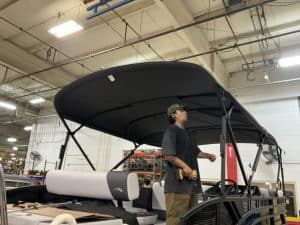 Opti boat canopy installation for enhanced protection and style.