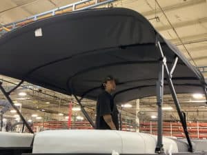 Boat canopy with sturdy black fabric and metal support structure.