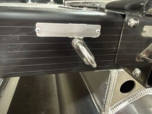 Boat engine control panel with throttle and identification plate.