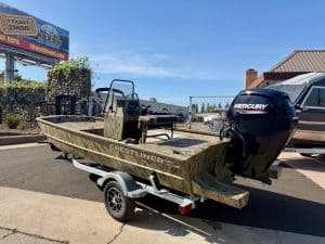 Crestliner aluminum boat with Mercury outboard motor on trailer, ready for fishing or water adventur.