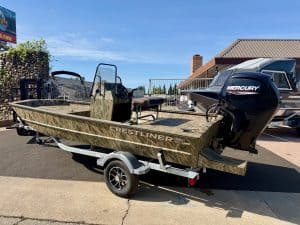 Aluminum Crestliner fishing boat with Mercury outboard motor on trailer for sale.