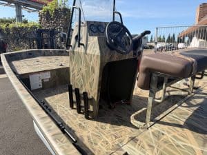 Marine boat with camouflage steering console, ideal for fishing and leisure.