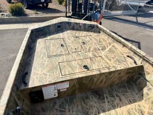 Boat deck with camouflage design, ideal for outdoor fishing and marine adventures.