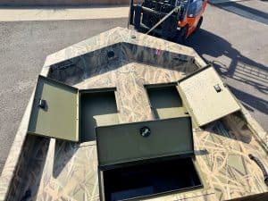 Aluminum boat with storage compartments for fishing or boating.