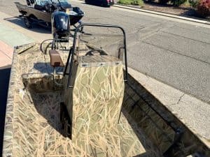 Boat with camouflage design, ideal for outdoor fishing and hunting adventures.