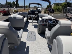 Pontoon boat cockpit with comfortable seating and steering controls.
