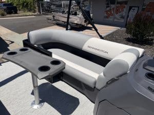 Bennington pontoon boat featuring comfortable lounge seating and a built-in table, ideal for relaxin.