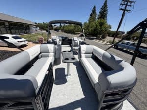 Modern pontoon boat with spacious seating and canopy, ideal for leisure and fishing.