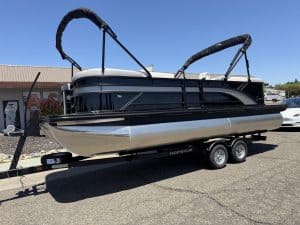 Modern pontoon boat on trailer, perfect for leisure and water adventures.
