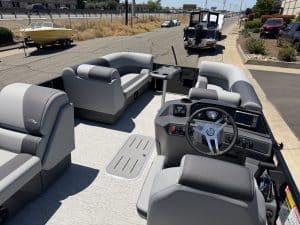 Modern pontoon boat interior with comfortable seating and advanced steering controls.