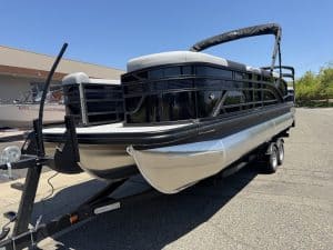 Premium pontoon boat with sleek black exterior and spacious deck, ideal for leisure and water advent.