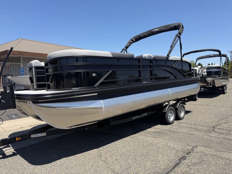 Modern pontoon boat with black and silver design, perfect for leisure and water sports.