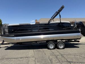 Pontoon boat with canopy, trailer, and outboard motor for sale at ASFB Marine.