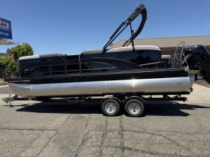 Pontoon boat with outboard motor on trailer for sale at ASFB Marine.