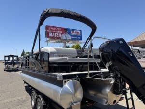 Modern pontoon boat with outboard motor, ideal for leisure and fishing.