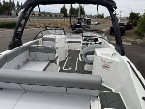 Recreational boat interior featuring steering console, seating, and canopy for outdoor adventures.