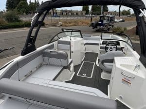 Modern pontoon boat interior with spacious seating and steering console for leisure activities.