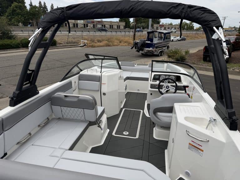 Modern boat interior with seating, steering, and safety features for optimal marine experience.