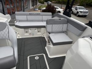 Modern Bayliner boat interior featuring comfortable seating and control panel for optimal boating ex.