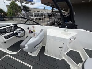Boat helm station with navigation controls, steering wheel, and comfortable seating for optimal mari.