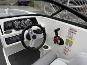 Marine boat helm with steering wheel, gauges, and control system for optimal navigation.