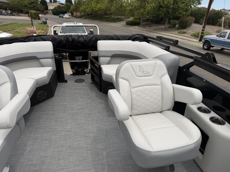 Modern boat interior with white seating and captain's chair for optimal comfort.