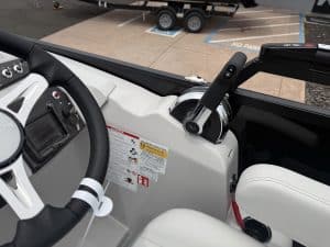 Modern boat cockpit dashboard with steering wheel and control systems for optimal navigation.
