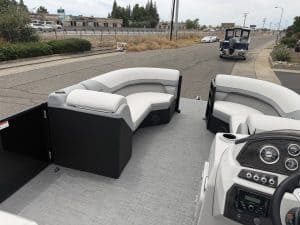 Boat seating and dashboard setup on a pontoon boat for marine leisure.