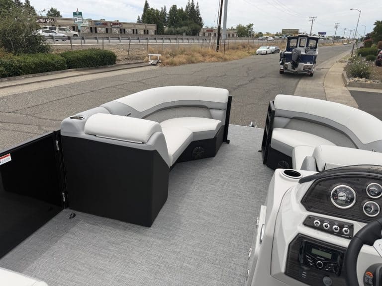 Boat seating and dashboard setup on a pontoon boat for marine leisure.