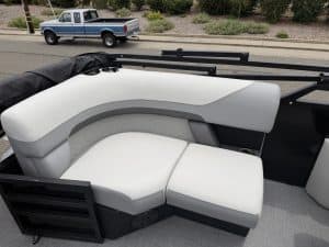 Pontoon boat interior with plush white cushions and sleek design.