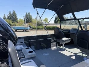 Boat interior with seating and steering console for sale.