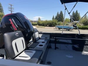 Boat interior with Mercury outboard engine and seating.