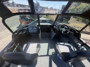 Boat cockpit interior with steering wheel and control panel for Crestliner 1850 Kodiak.