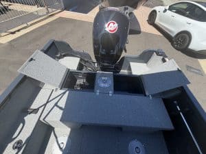 Boat deck with Mercury 115HP Pro Xs outboard engine and storage compartments.