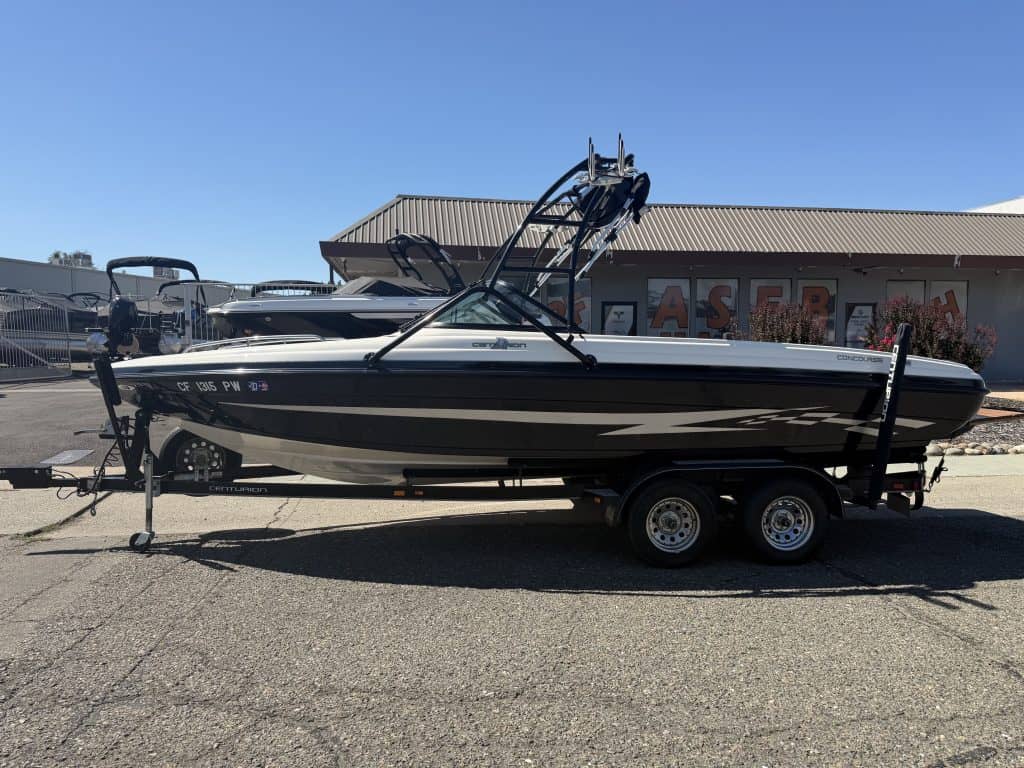 2002 Centurion Typhoon speedboat on trailer at dealership.