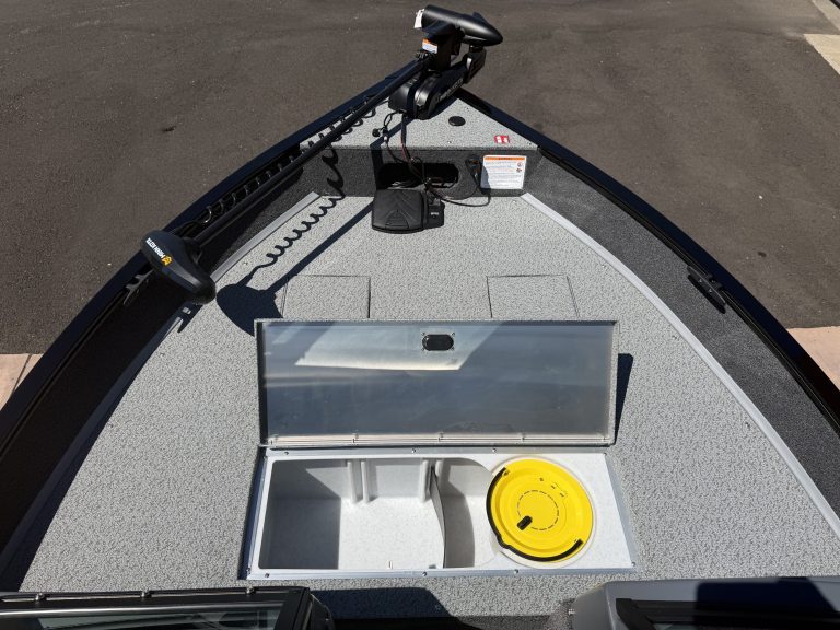 Boat deck with storage hatch and electronic equipment for fishing or boating.