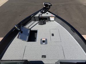 Boat deck with electronics and storage compartments for fishing or leisure.